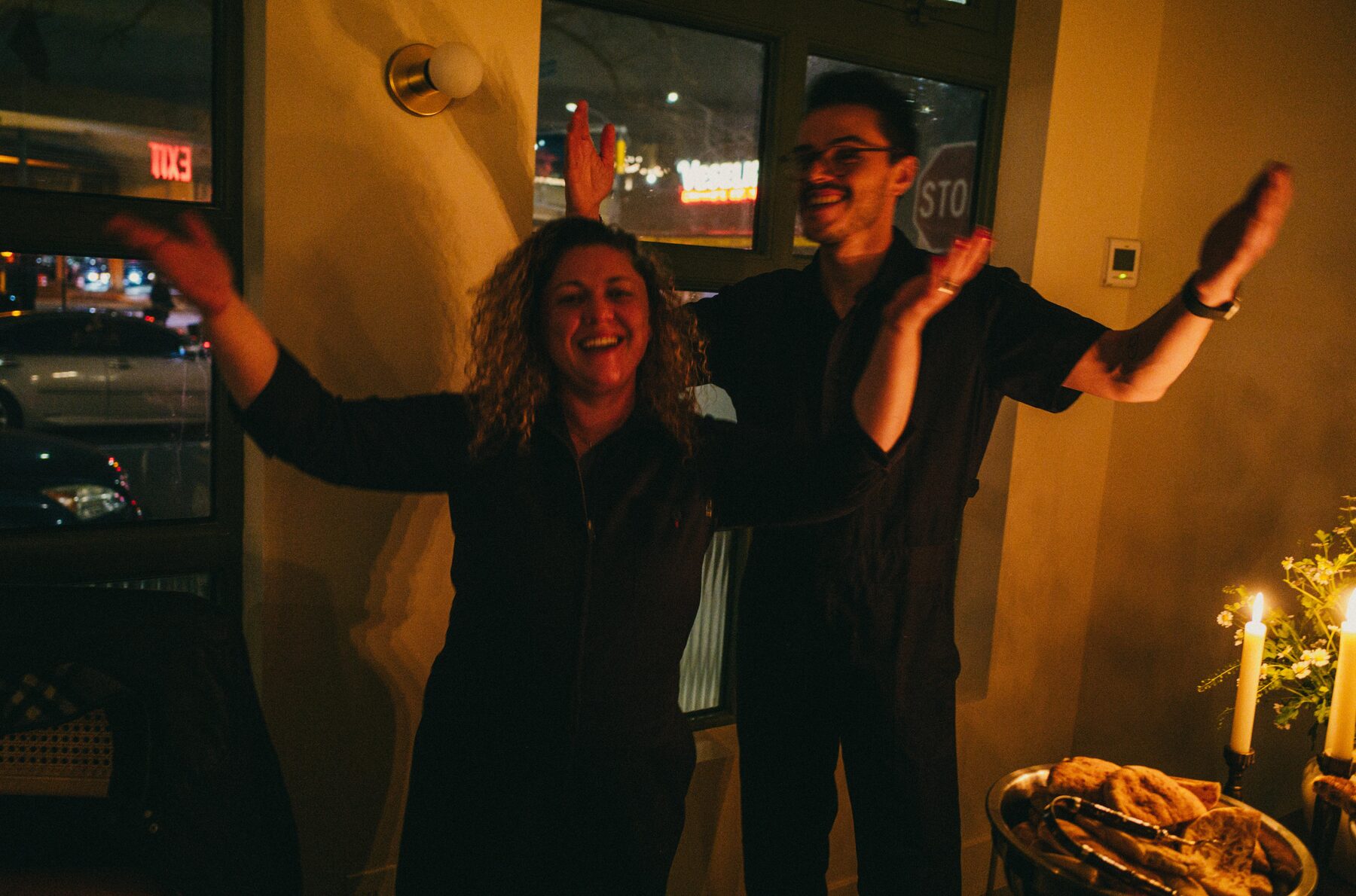 Santiago Arboleda and a colleague celebrating beside a candlelit event table