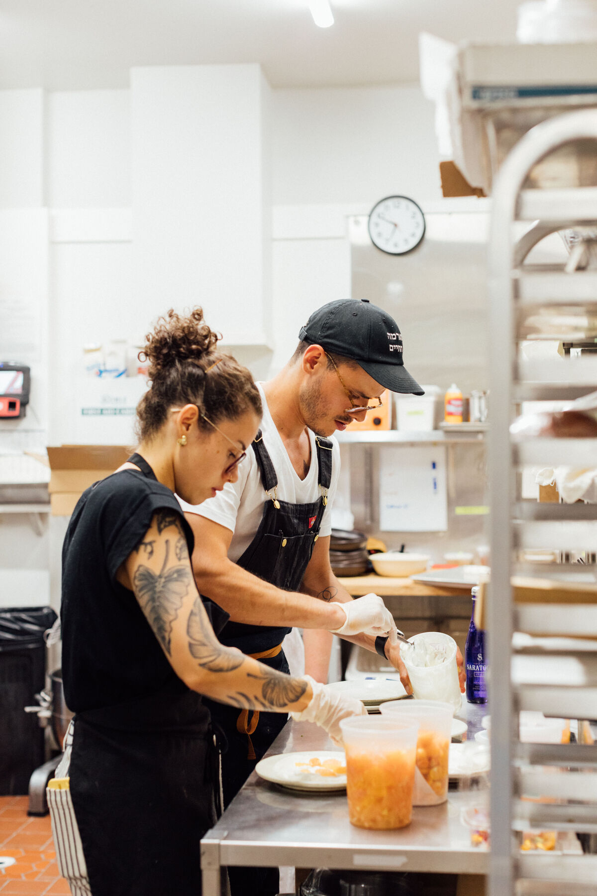 Santiago Arboleda and a colleague preparing plates together in the restaurant kitchen