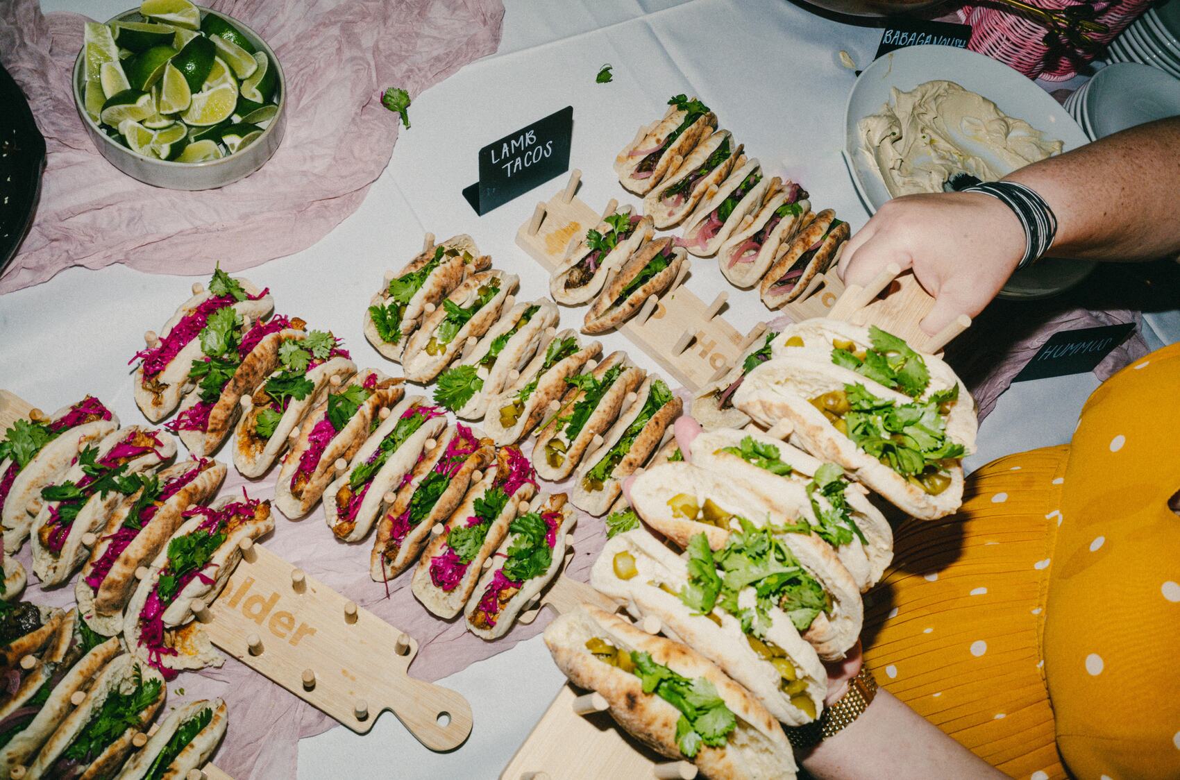 A large labeled assortment of pitas being served at a Reunion event